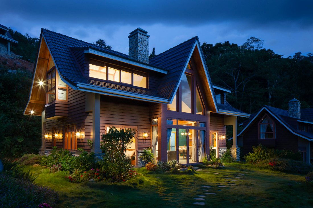 A family home lit up at dusk